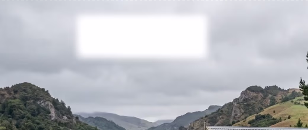 The same patch after several passes with the Blur brush, its edge softened into the sky
